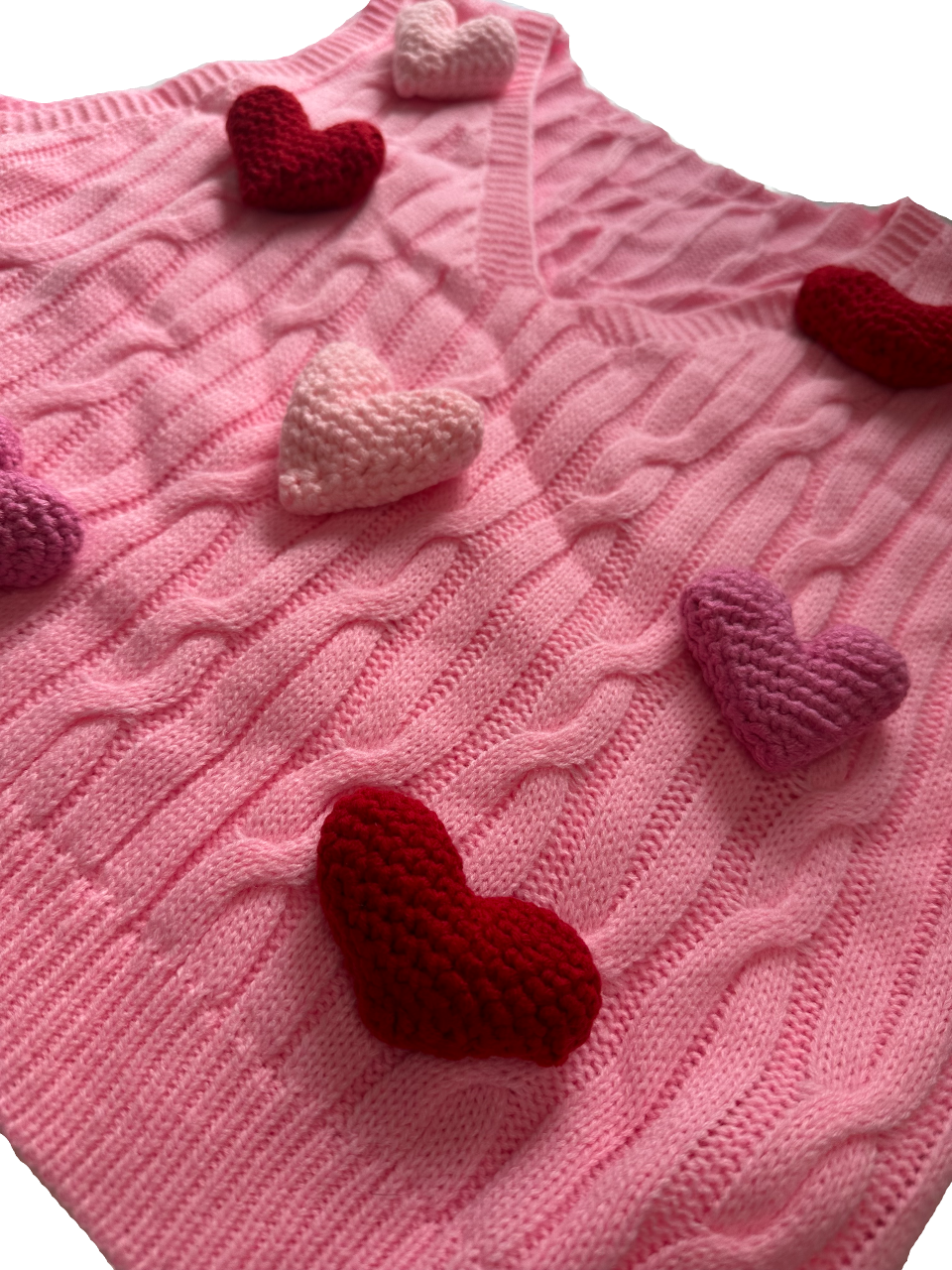 Pink vest adorned with 3D hearts in shades of pink and red.